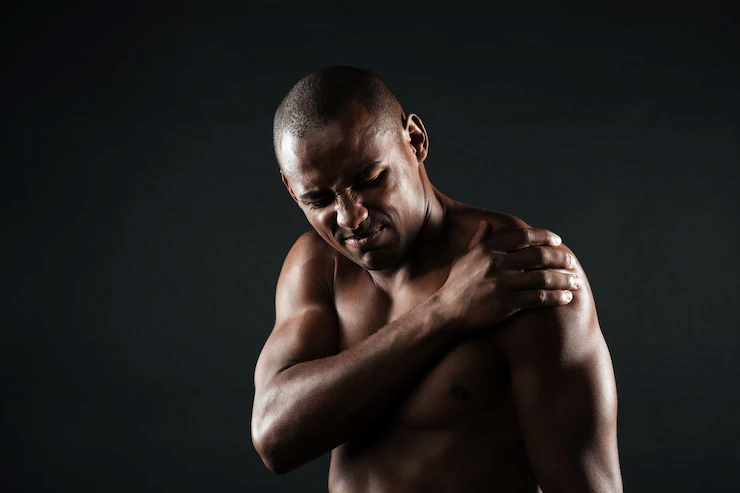 Shirtless man with shoulder pain